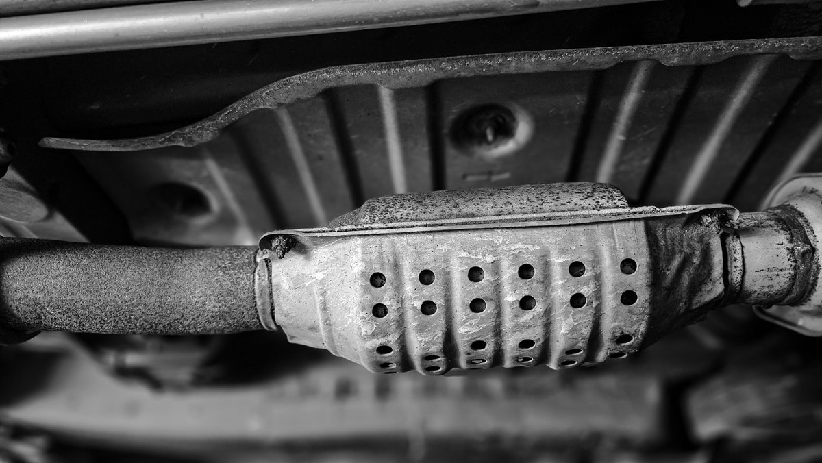 Catalytic converter with its ceramic honeycomb interior visible