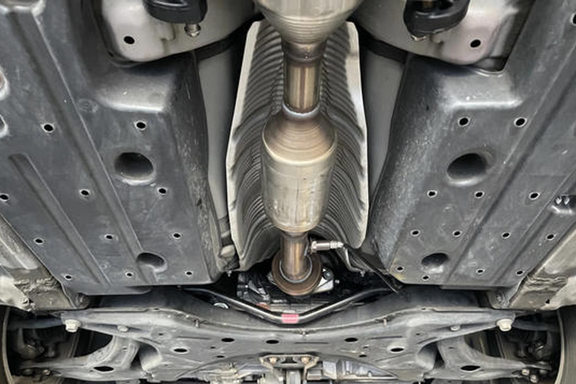 Catalytic converter and exhaust running along the underside of a vehicle