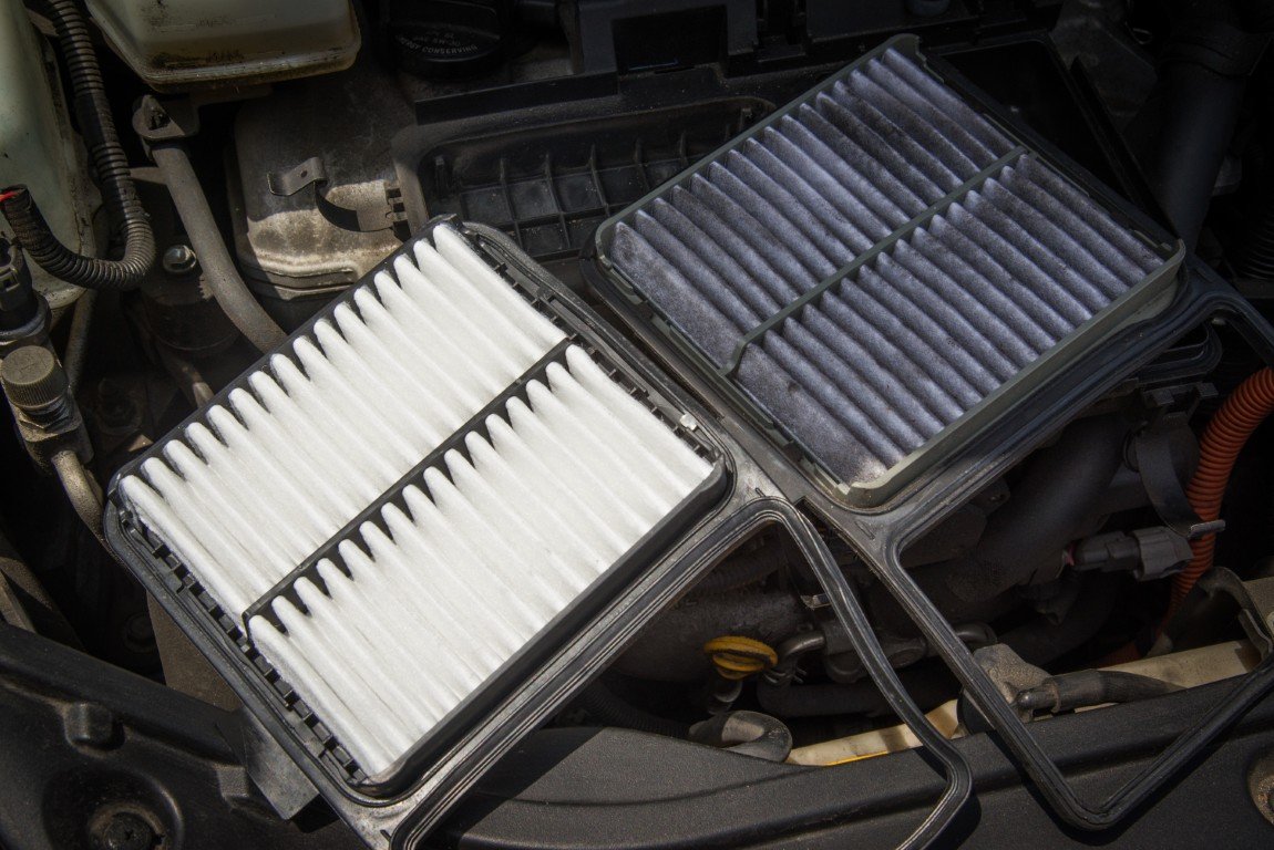 Clean engine air filter shown beside a dirty one removed from a vehicle airbox