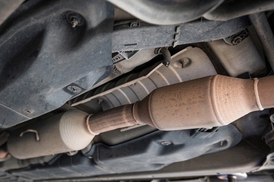 Catalytic converter and exhaust pipe beneath a vehicle