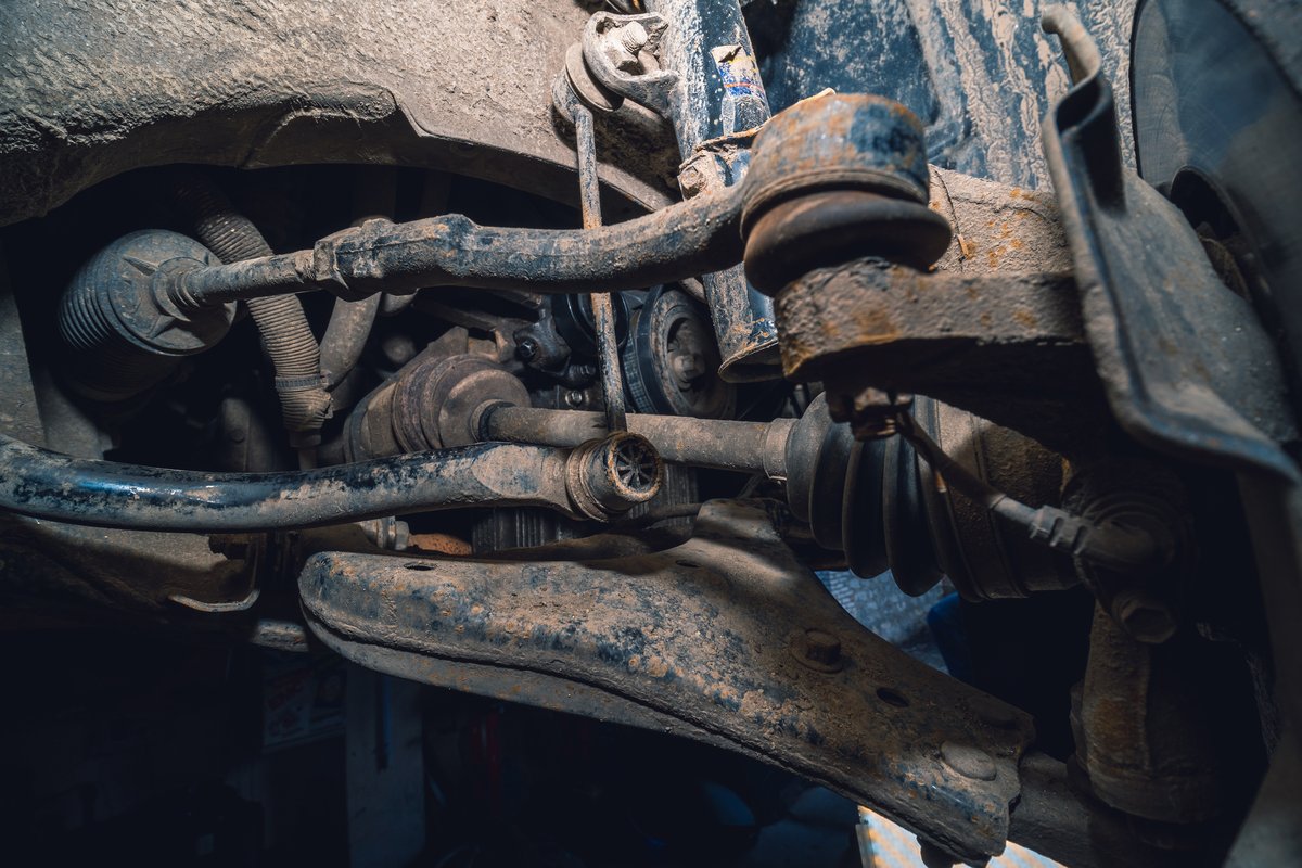 Steering rack and tie rod components viewed from beneath a vehicle