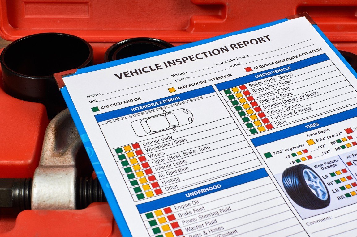 Printed vehicle inspection report resting in an open tool case