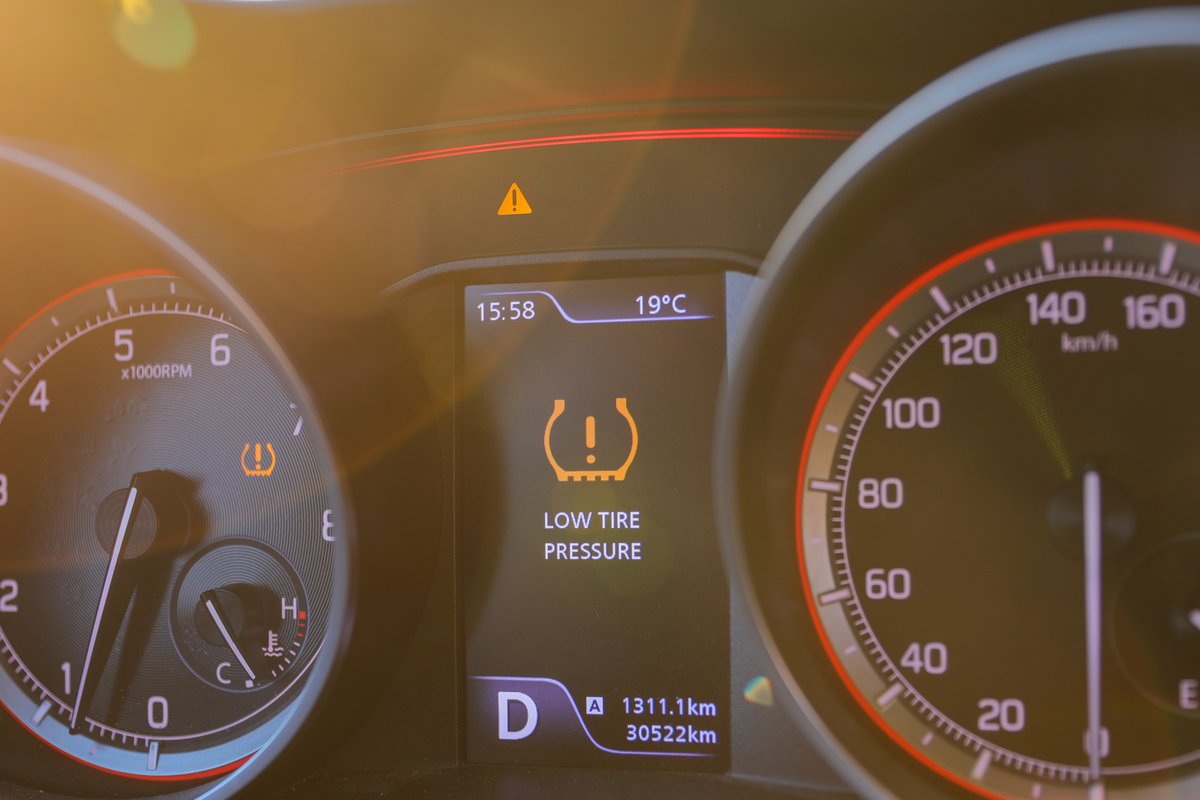 Dashboard display showing a low tire pressure warning and TPMS symbol